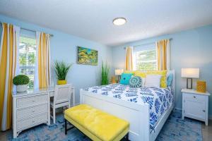 a blue bedroom with a bed and a desk and a table at Walk to the Beach Family Bungalow - 5 min to beach in Naples +22 photos