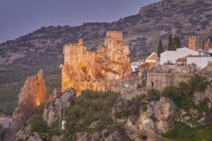 a castle sitting on top of a mountain at PoolHouse in the Historic Center in Baena