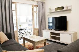 a living room with a couch and a flat screen tv at Nuevo apartamento de 3 dormitorios en calle Alta in Santander