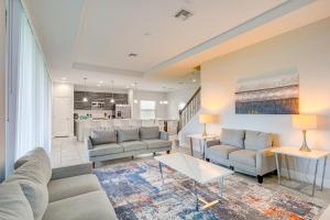 a living room with two couches and a table at Near Disney and Legoland Spacious Poolside Oasis! in Haines City