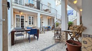 un patio extérieur avec des chaises, une table et des tables dans l'établissement BmyT - The Villa, à Lisbonne