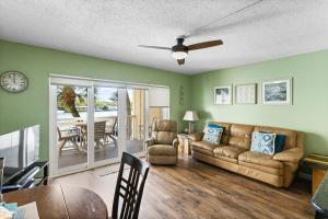 a living room with a couch and a table at Fifty Gulfside Condominiums in Clearwater Beach