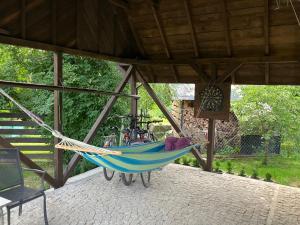 a hammock hanging from a roof in a porch at Duży komfortowy apartament in Grajewo