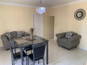 a living room with a table and chairs and a couch at Saunders Beach Manor and Pool in Nassau