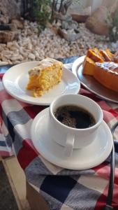 a cup of coffee and a piece of cake on a table at Cheverny Apart Hotel in Belo Horizonte +51 photos