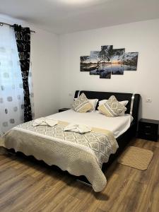 a bedroom with a bed with two pillows on it at Casa Angy in Jurilovca