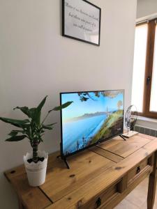 a flat screen tv sitting on top of a wooden table at Pine`s Lodge , private Wi-FI in Bansko