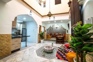 a living room with a couch and a table at Authentic Agadir Riad Walk to All Sights in Agadir