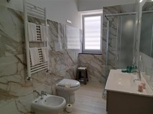 a bathroom with a toilet and a sink and a shower at Casa Vacanze Argento in Bacoli +19 photos
