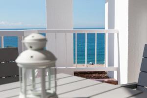 una vista del océano desde un balcón en SeaHomes Vacations - Seafront Apt Fenals with PKG, en Lloret de Mar