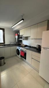 a kitchen with a stove and a dishwasher in it at Guesthouse Park in Córdoba