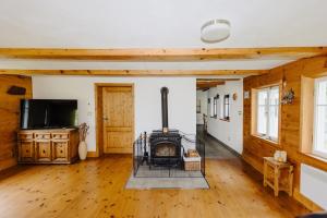 Televízia a/alebo spoločenská miestnosť v ubytovaní Forest View Cottage
