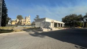 a white building with a church in the background at Guesthouse Park in Córdoba