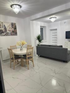 a living room with a table and a couch at Apartament Grójec in Grójec +20 photos