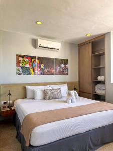 a bedroom with a large bed in a room at Hotelito del Mar Playa del Carmen in Playa del Carmen +60 photos
