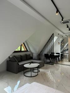 a living room with a couch and a table at Yeti Studio Apartament Krupówki 73C in Zakopane
