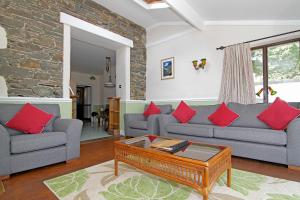 a living room with two couches and a coffee table at Embleton Spa Hotel & Apartments in Embleton