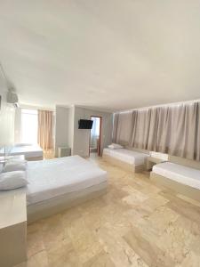 Postel nebo postele na pokoji v ubytování Hotel Cartagena Premium