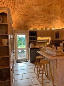a kitchen with a counter and two bar stools at Castle Oliver Farm in Ardpatrick +25 photos