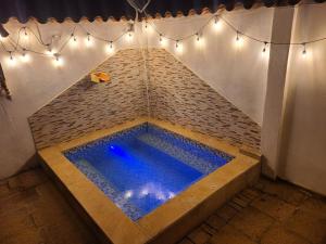a large swimming pool in a brick wall with lights at Alemau´s House Casa Hospedaje en Barichara in Barichara