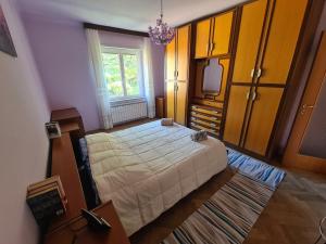 a bedroom with a large bed and a television at Casa Lisa in Trieste