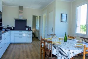 a kitchen and dining room with a table and chairs at Ker Stivell in Roscanvel