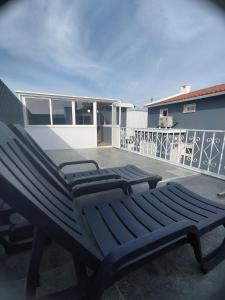 a pair of benches sitting on a patio at Casa sintra in São Domingos de Rana