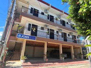 a building with a sign on the side of it at Studio apartment in Mactan,Cebu-Room201 in Mactan