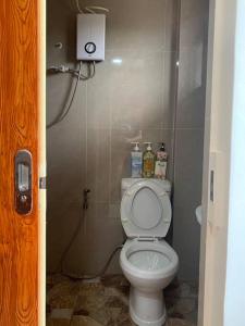 a bathroom with a white toilet in a stall at Studio apartment in Mactan,Cebu-Room201 in Mactan +13 photos