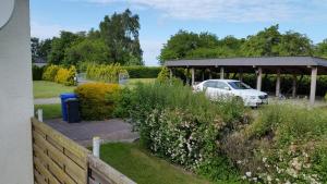 a car parked under a pavilion in a garden at Fewo beim Saalerbodden in Bartelshagen