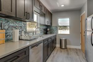 a kitchen with a sink and a refrigerator at 7 Mi to Denver Inviting Aurora Home with Yard! in Aurora