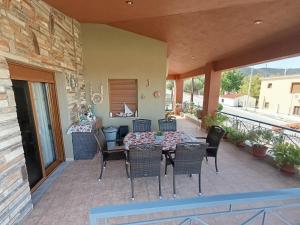 a porch with a table and chairs on a patio at VILLA NIKOLETTA in Eleftheroúpolis