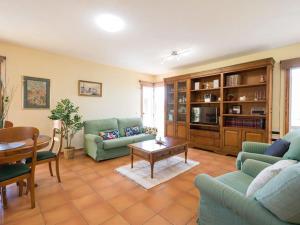 a living room with two couches and a table at Ático Rural VistaTeide in El Palmital