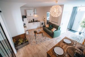 an overhead view of a living room and a kitchen at LES PETITS ROYS - Proche centre ville - Cosy in Châteauroux +31 photos