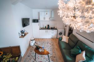 a living room with a couch and a table at LES PETITS ROYS - Proche centre ville - Cosy in Châteauroux