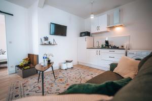 a living room with a couch and a table at LES PETITS ROYS - Proche centre ville - Cosy in Châteauroux