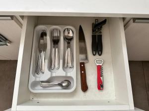 a drawer with silver utensils in a cabinet at Moderno Studio en Calacoto in Achumani