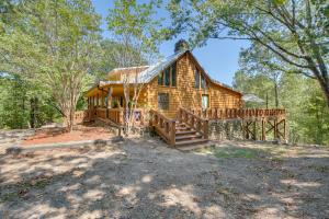 a log cabin in the woods with a large deck at Hot Springs Cabin w/ Deck + Mountain Views! in Hot Springs