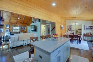 a kitchen and living room with a couch and a table at Hot Springs Cabin w/ Deck + Mountain Views! in Hot Springs