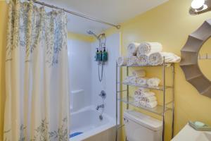 a bathroom with a shower and a toilet and towels at Hot Springs Cabin w/ Deck + Mountain Views! in Hot Springs +18 photos