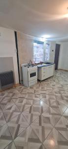 an empty room with a kitchen with a stove at Casita, NOFA in Ushuaia