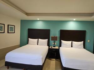 Postel nebo postele na pokoji v ubytování Hotel Maria Elena