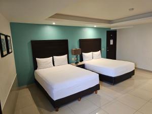 Postel nebo postele na pokoji v ubytování Hotel Maria Elena