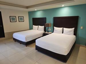 Postel nebo postele na pokoji v ubytování Hotel Maria Elena