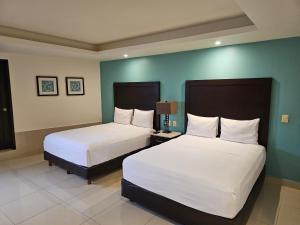 Postel nebo postele na pokoji v ubytování Hotel Maria Elena