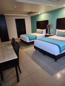 Postel nebo postele na pokoji v ubytování Hotel Maria Elena