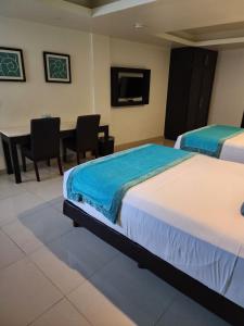 Postel nebo postele na pokoji v ubytování Hotel Maria Elena