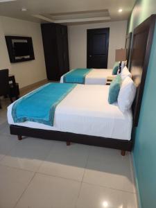 Postel nebo postele na pokoji v ubytování Hotel Maria Elena