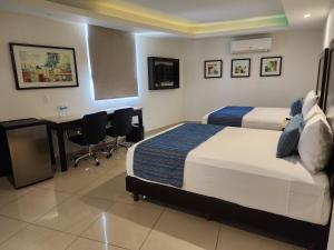 Postel nebo postele na pokoji v ubytování Hotel Maria Elena