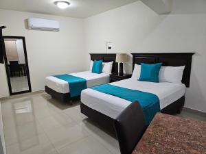Postel nebo postele na pokoji v ubytování Hotel Maria Elena